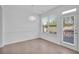 Dining room with big window, access to outdoor patio and hardwood floors at 7545 Roseberry Way, Lithonia, GA 30038