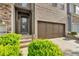 Close-up of this brick townhome with an attached two-car garage and well-maintained landscaping at 7545 Roseberry Way, Lithonia, GA 30038