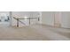 Upstairs hallway featuring neutral carpeting, white railings, and a glimpse of a bedroom at 7545 Roseberry Way, Lithonia, GA 30038