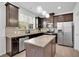 Kitchen featuring stainless steel appliances, granite countertops, an island and natural light at 7545 Roseberry Way, Lithonia, GA 30038