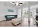 Spacious living room with a gray sofa and ottoman, hardwood floors, coffered ceiling, and open layout at 7545 Roseberry Way, Lithonia, GA 30038