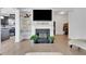 Cozy living room featuring a fireplace, built-in shelves, hardwood floors, and an open floor plan at 7545 Roseberry Way, Lithonia, GA 30038