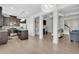 Bright, open-concept living space with hardwood floors, modern lighting, and kitchen with stainless steel appliances at 7545 Roseberry Way, Lithonia, GA 30038