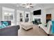 Open-concept living room featuring a fireplace, hardwood floors, coffered ceiling, and views of the kitchen at 7545 Roseberry Way, Lithonia, GA 30038