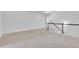 Bright loft space features neutral carpeting and a staircase with white spindles and dark wood handrail at 7545 Roseberry Way, Lithonia, GA 30038