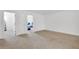 Spacious loft area showcasing access to other rooms and neutral carpeting throughout at 7545 Roseberry Way, Lithonia, GA 30038