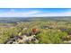 A high aerial shot of a home surrounded by lush forestry, showcasing its peaceful location at 7801 Windswept Way, Douglasville, GA 30135