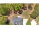 Aerial view of a home with a large deck, surrounded by lush greenery and mature trees at 7801 Windswept Way, Douglasville, GA 30135