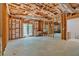 Unfinished basement with french doors, exposed ductwork, and concrete flooring at 7801 Windswept Way, Douglasville, GA 30135
