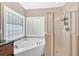 Modern bathroom showing a corner soaking tub with jets and a glass-enclosed shower at 7801 Windswept Way, Douglasville, GA 30135