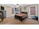 Neutral toned bedroom with a ceiling fan and natural light at 7801 Windswept Way, Douglasville, GA 30135