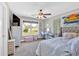 Bright bedroom with a ceiling fan, window, desk, and light-colored walls at 7801 Windswept Way, Douglasville, GA 30135