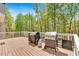 Wooden deck with white railings, ideal for outdoor entertaining with wooded views at 7801 Windswept Way, Douglasville, GA 30135