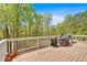 Wooden deck with white railings, offering a serene outdoor space with wooded views at 7801 Windswept Way, Douglasville, GA 30135