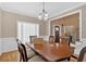 Traditional dining room with hardwood floors, classic chandelier, and views to the front foyer at 7801 Windswept Way, Douglasville, GA 30135