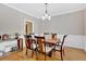 Formal dining room featuring hardwood floors and a modern chandelier over the wooden table at 7801 Windswept Way, Douglasville, GA 30135