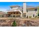 Exterior of the home from the backyard showing the elevated deck and lush green trees at 7801 Windswept Way, Douglasville, GA 30135