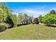 Desirable home exterior showcasing the lawn, plants, and driveway at 7801 Windswept Way, Douglasville, GA 30135