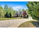 Lovely home with a long driveway and surrounded by mature trees at 7801 Windswept Way, Douglasville, GA 30135