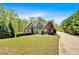 Attractive home with lush landscaping and a long, paved driveway at 7801 Windswept Way, Douglasville, GA 30135
