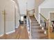 Inviting foyer with hardwood floors, staircase, and view into the living area at 7801 Windswept Way, Douglasville, GA 30135
