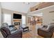 Bright living room with fireplace, hardwood floors, and vaulted ceilings open to adjacent kitchen at 7801 Windswept Way, Douglasville, GA 30135