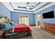 Large main bedroom with tray ceiling, TV, dresser, and ensuite bath access at 7801 Windswept Way, Douglasville, GA 30135
