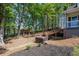 Landscaped backyard featuring a hot tub, wooden bridge, and storage shed at 8132 Union Hill Rd, Canton, GA 30115