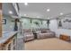 Cozy basement with a lounge area, fishing décor, and a painted brick wall at 8132 Union Hill Rd, Canton, GA 30115