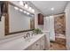 Bathroom featuring a white vanity, framed mirror, tile floor and tile shower with a tub at 8132 Union Hill Rd, Canton, GA 30115
