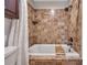 Close up of the bathtub with tiled shower, and a decorative shelf in this bathroom at 8132 Union Hill Rd, Canton, GA 30115