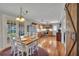 Dining area with wood table, white chairs, view to kitchen, and French doors to screened in porch at 8132 Union Hill Rd, Canton, GA 30115