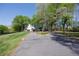 Long, paved driveway leading to a charming home nestled among mature trees and well-maintained landscaping at 8132 Union Hill Rd, Canton, GA 30115