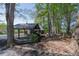 Secluded home featuring a covered parking area nestled among mature trees and landscaping at 8132 Union Hill Rd, Canton, GA 30115