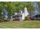Beautiful home featuring a welcoming front porch and lush landscaping, set on a sprawling green lawn at 8132 Union Hill Rd, Canton, GA 30115