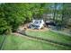 Charming home featuring a large, grassy yard, a quaint front porch, and a convenient carport at 8132 Union Hill Rd, Canton, GA 30115