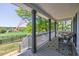Enjoy scenic views from this cozy front porch, complete with stylish outdoor furniture and a charming rug at 8132 Union Hill Rd, Canton, GA 30115