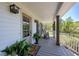 Charming front porch featuring decorative plants, a rocking chair, and a welcoming entryway at 8132 Union Hill Rd, Canton, GA 30115