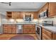 Kitchen showcasing wood cabinetry, stainless steel appliances, and hardwood flooring at 8132 Union Hill Rd, Canton, GA 30115