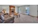 Bright living room featuring a brick fireplace, comfortable seating, and ample natural light from the windows at 8132 Union Hill Rd, Canton, GA 30115