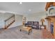 Comfortable living room featuring a fireplace, neutral carpet, and view of the staircase at 8132 Union Hill Rd, Canton, GA 30115