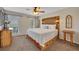 Cozy main bedroom with a wood-accented headboard, ceiling fan, and two large windows at 8132 Union Hill Rd, Canton, GA 30115