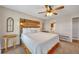 Bedroom featuring wood headboard with lights, ceiling fan, neutral color palette, and two windows at 8132 Union Hill Rd, Canton, GA 30115
