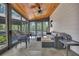Relaxing sunroom with tile floors, wood ceiling, and screened windows overlooking nature at 8132 Union Hill Rd, Canton, GA 30115