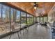 Sunroom with tiled floors and views of the wooded backyard at 8132 Union Hill Rd, Canton, GA 30115