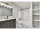 Stylish bathroom featuring a vanity, toilet, shower, and open shelving, offering a modern and functional space at 1415 Eric Se St, Atlanta, GA 30315