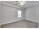 Serene bedroom with neutral tones, soft carpeting, and a ceiling fan, creating a tranquil and comfortable environment at 1415 Eric Se St, Atlanta, GA 30315