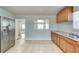 Bright kitchen with stainless steel refrigerator and pass-through to dining area at 1415 Eric Se St, Atlanta, GA 30315