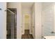 Bright bathroom featuring tile flooring, glass shower doors, and access to a walk-in closet at 2331 Bouldercliff Se Way, Atlanta, GA 30316