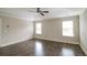 Bedroom with ceiling fan, tray ceiling, wood flooring, and natural light at 2331 Bouldercliff Se Way, Atlanta, GA 30316